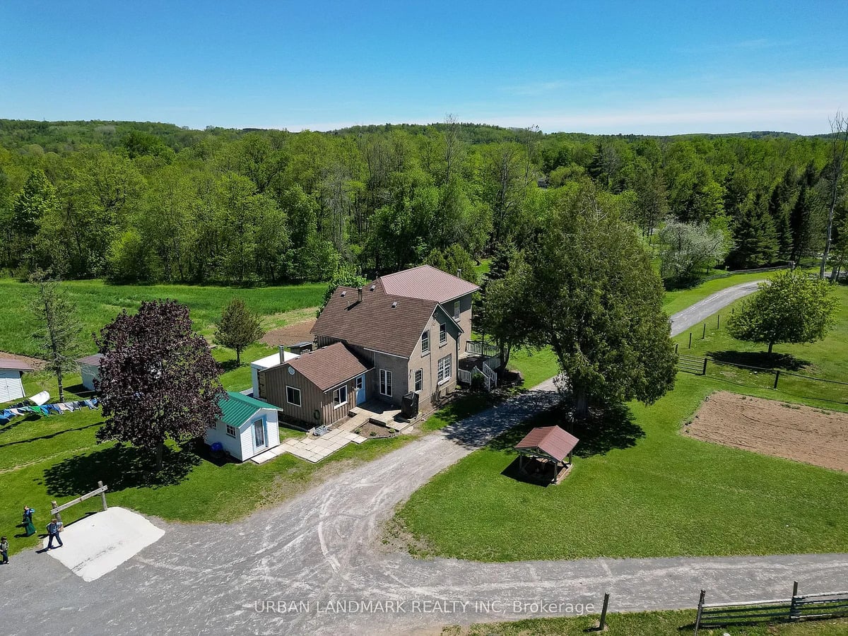 Amish farmhouse from above near Stirling, Ontario Aerial view of brick Amish farmhouse, outhouse, lane and woods near Stirling, Ontario