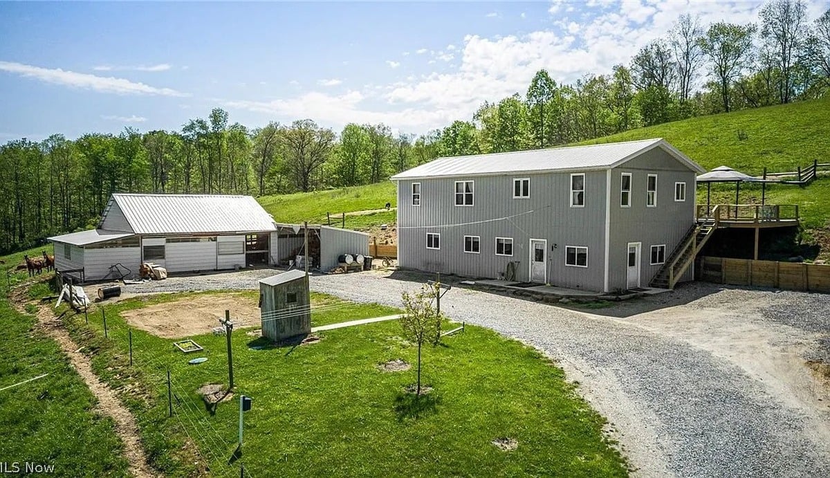Aerial view of Amish homestead in Cumberland Ohio with barn and horses visible