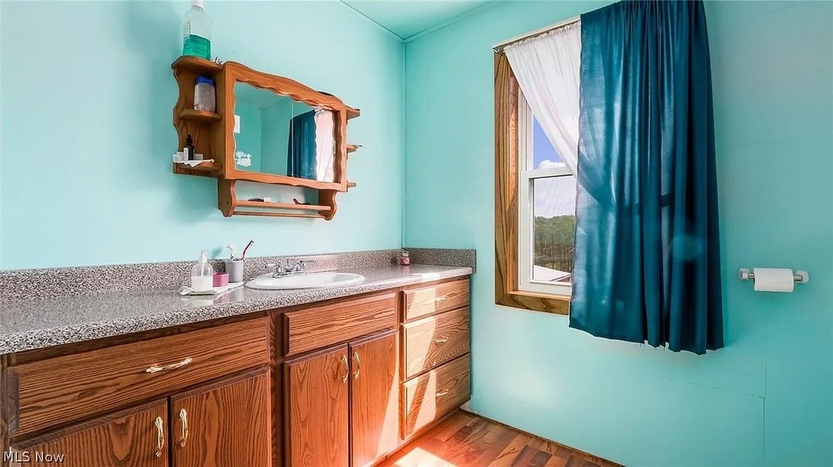 Bathroom vanity with Amish-made wooden cabinetry in Cumberland Ohio Amish home