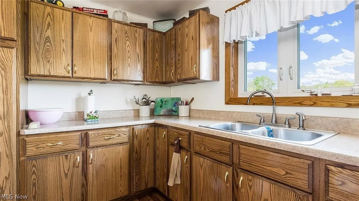 Kitchen in Amish home Cumberland Ohio with solid wood cabinets double sink and large window