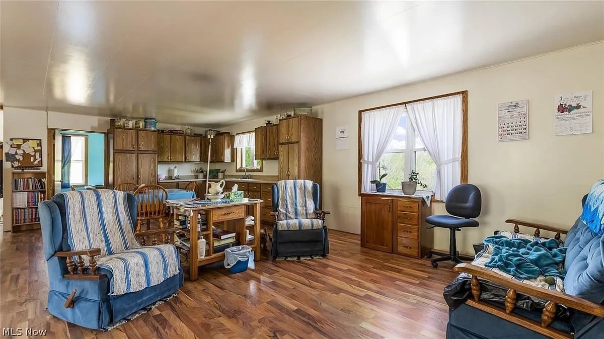 Living area and kitchen of Amish home in Cumberland Ohio with Amish-made wood cabinets