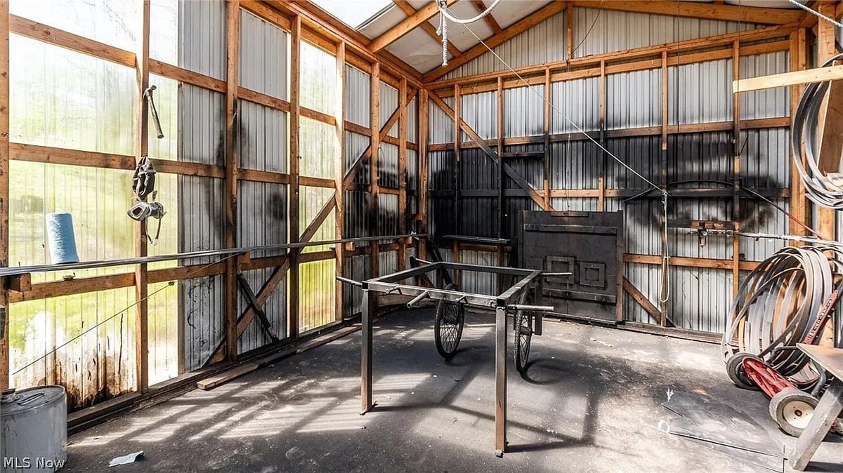 Buggy frame and wheel parts inside outbuilding at Amish homestead Cumberland Ohio