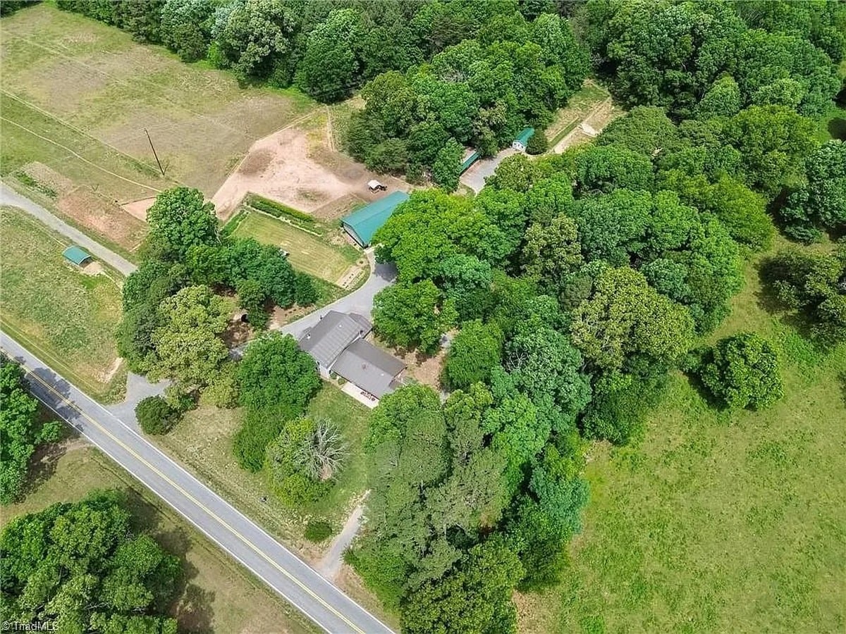 Aerial view of Amish property in Hamptonville, North Carolina showing home, green-roof barn, and road frontage on Saint Paul Church Road
