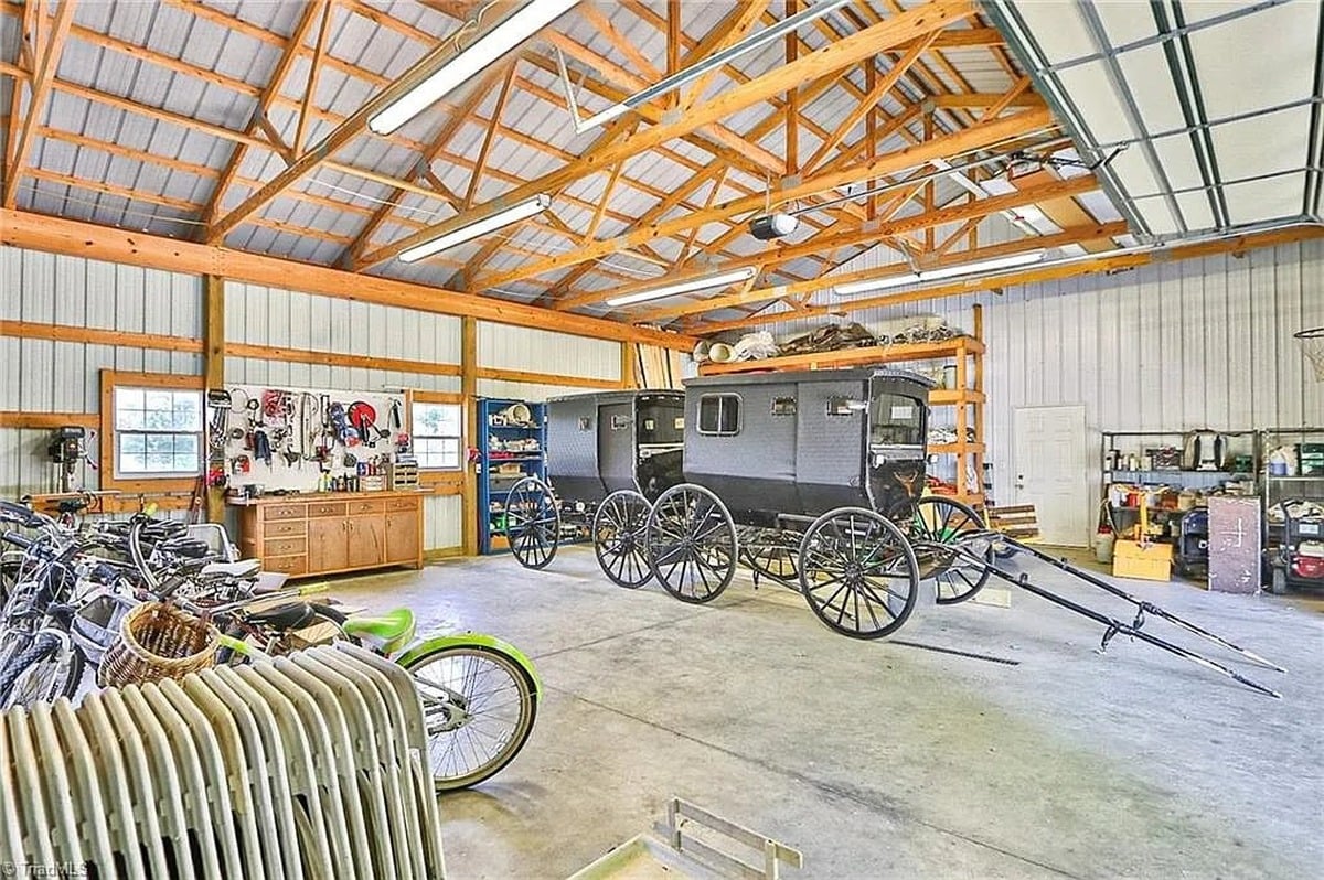 Amish buggy parked inside garage at Union Grove Amish home in Hamptonville, North Carolina, with bicycles along the wall