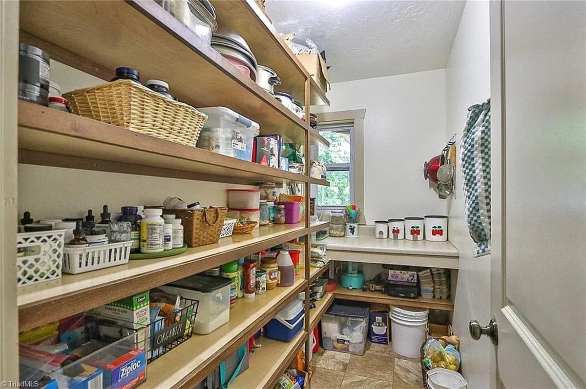Fully stocked pantry with floor-to-ceiling shelves at Amish home in Hamptonville, North Carolina