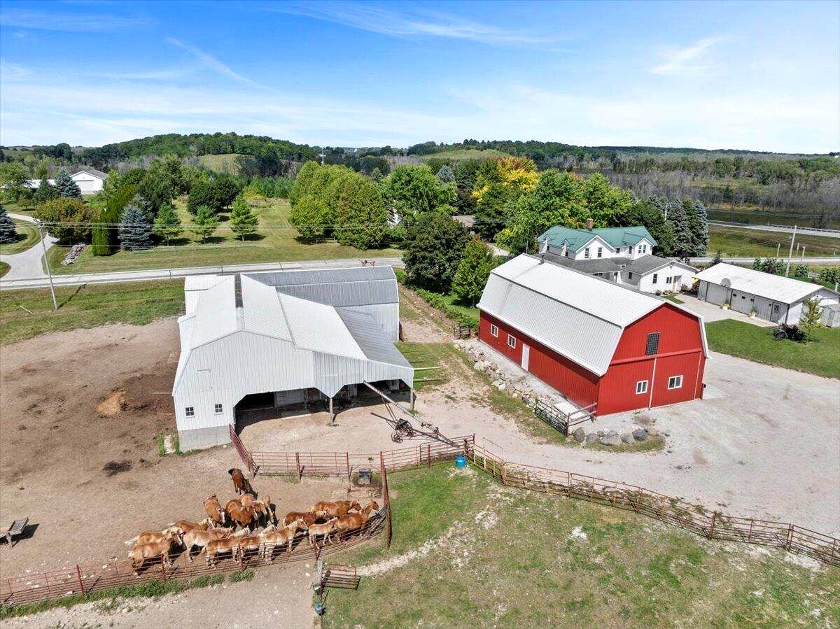 Aerial view of Amish farm in New Holstein, Wisconsin with cattle in pen and red barn