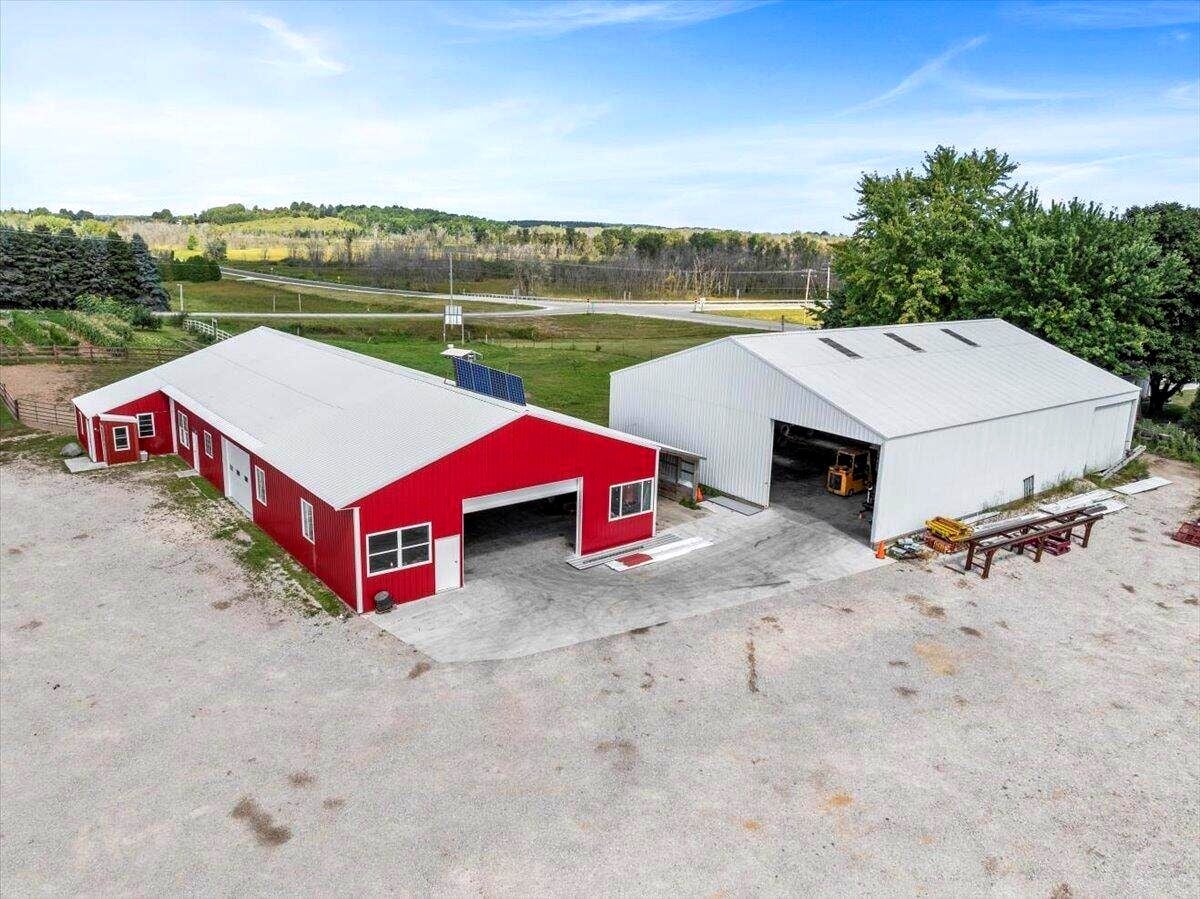 Wide aerial view of Amish farm compound in Calumet County, Wisconsin with green fields and farm buildings
