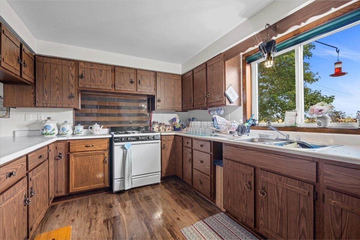 Kitchen detail with gas range and tile backsplash in Amish farmhouse, New Holstein, Wisconsin