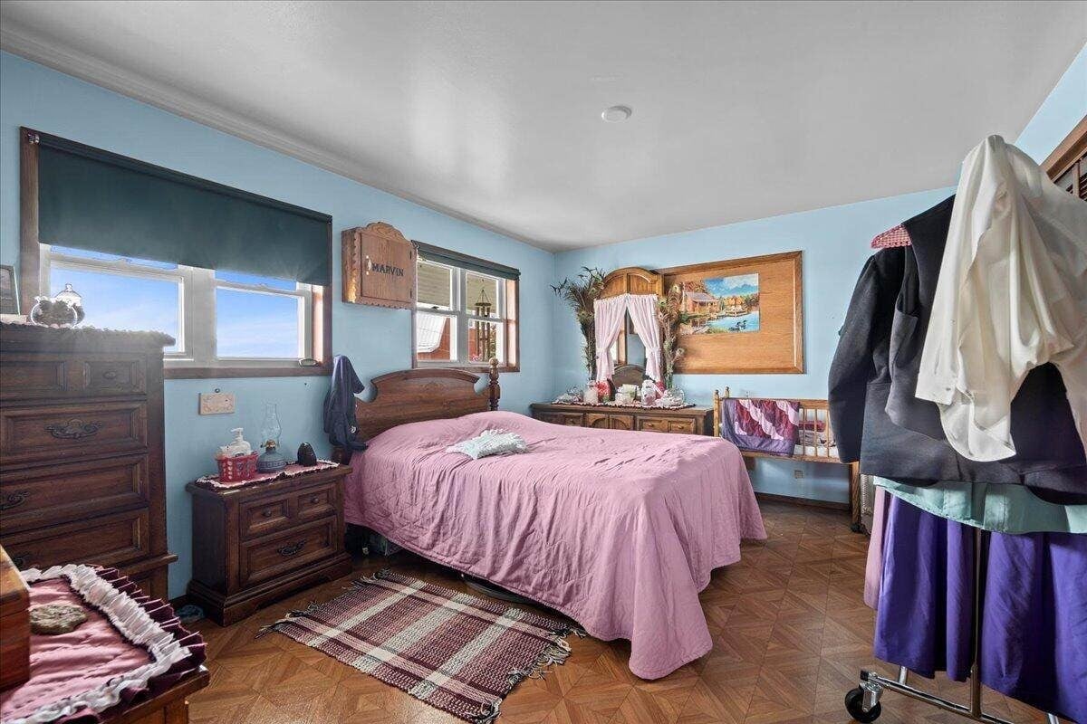 Main floor bedroom with Amish clothing on rack and Marvin name sign, New Holstein, Wisconsin farmhouse