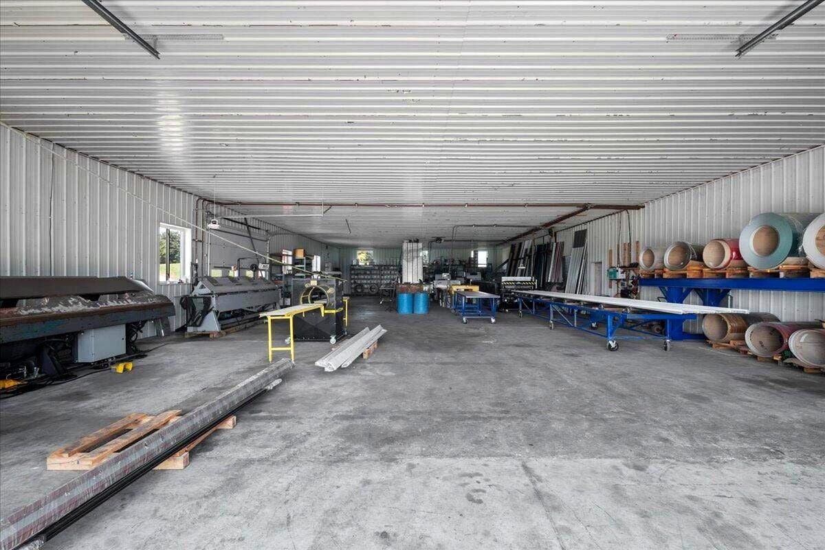 Wide interior view of Amish metal fabrication shop with rolling tables and coil stock, New Holstein, Wisconsin