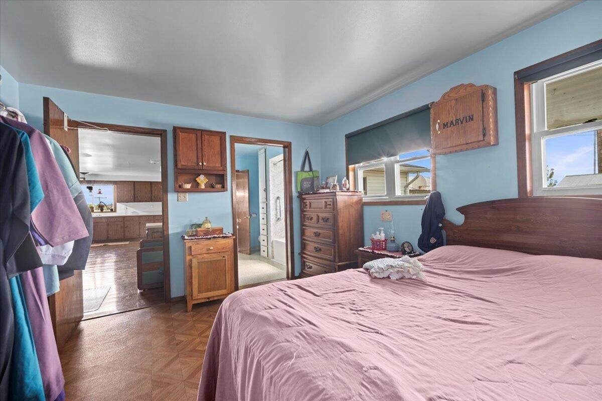 Upstairs bedroom with green walls and wood floors in Amish farmhouse, New Holstein, Wisconsin