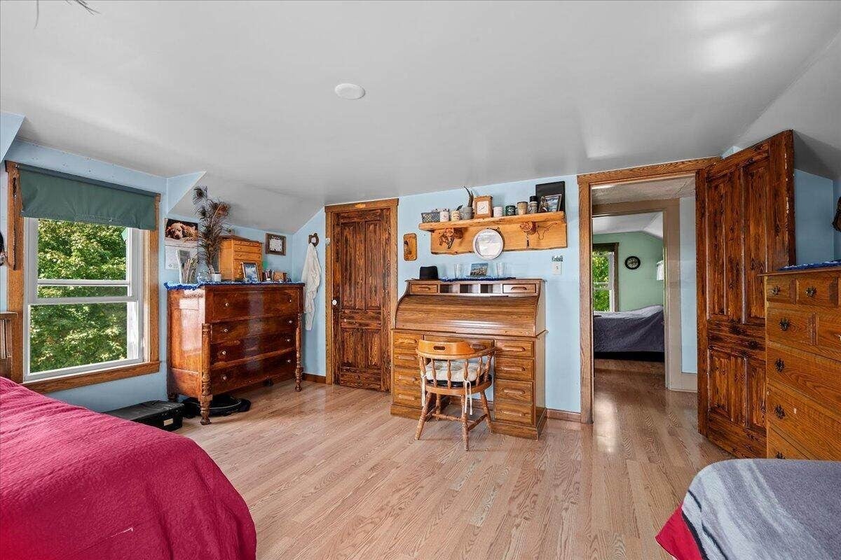 Upstairs bedroom with antique roll-top desk and wood dressers in Amish farmhouse, New Holstein, Wisconsin
