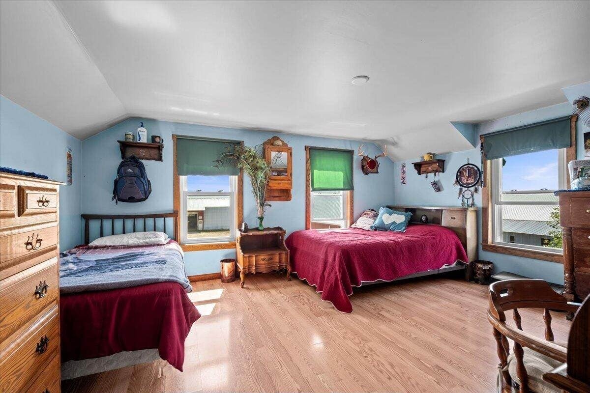 Upstairs bedroom with two beds and farm building views in Amish farmhouse, New Holstein, Wisconsin