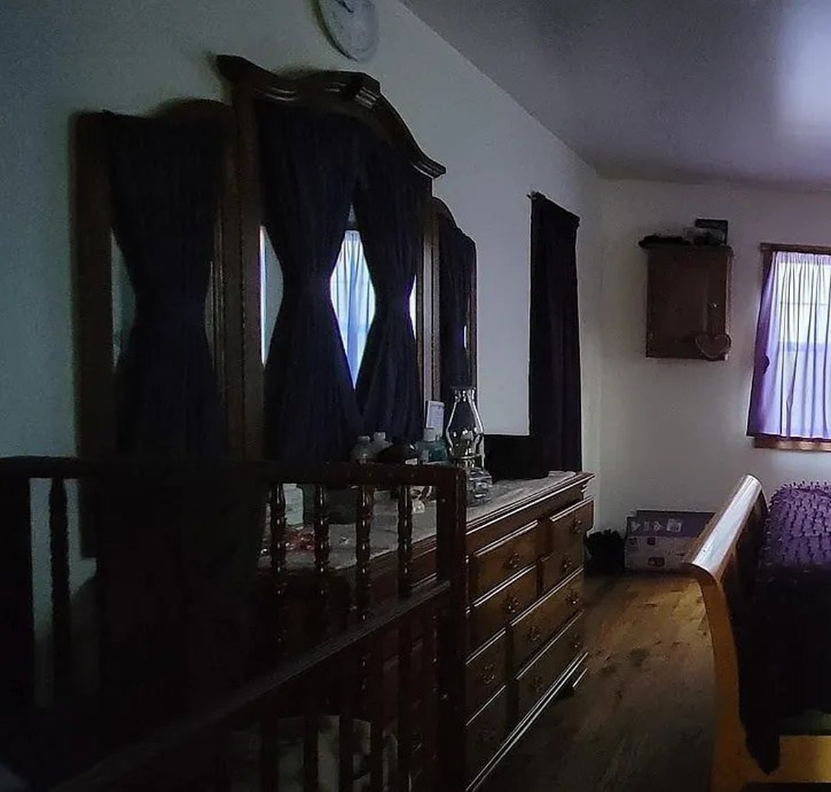 Dark wood dresser and mirror inside bedroom of Amish home in Vevay, Indiana