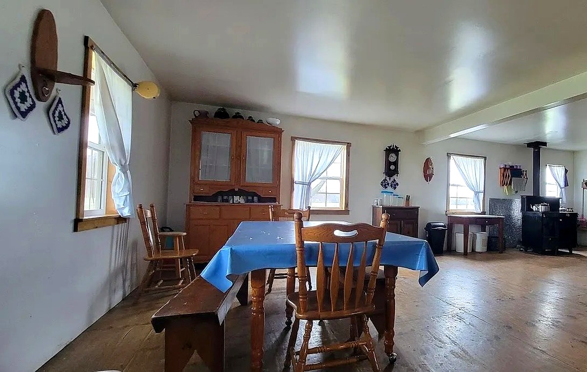 Dining table, wooden hutch, and wood stove inside Amish home in Vevay, Indiana
