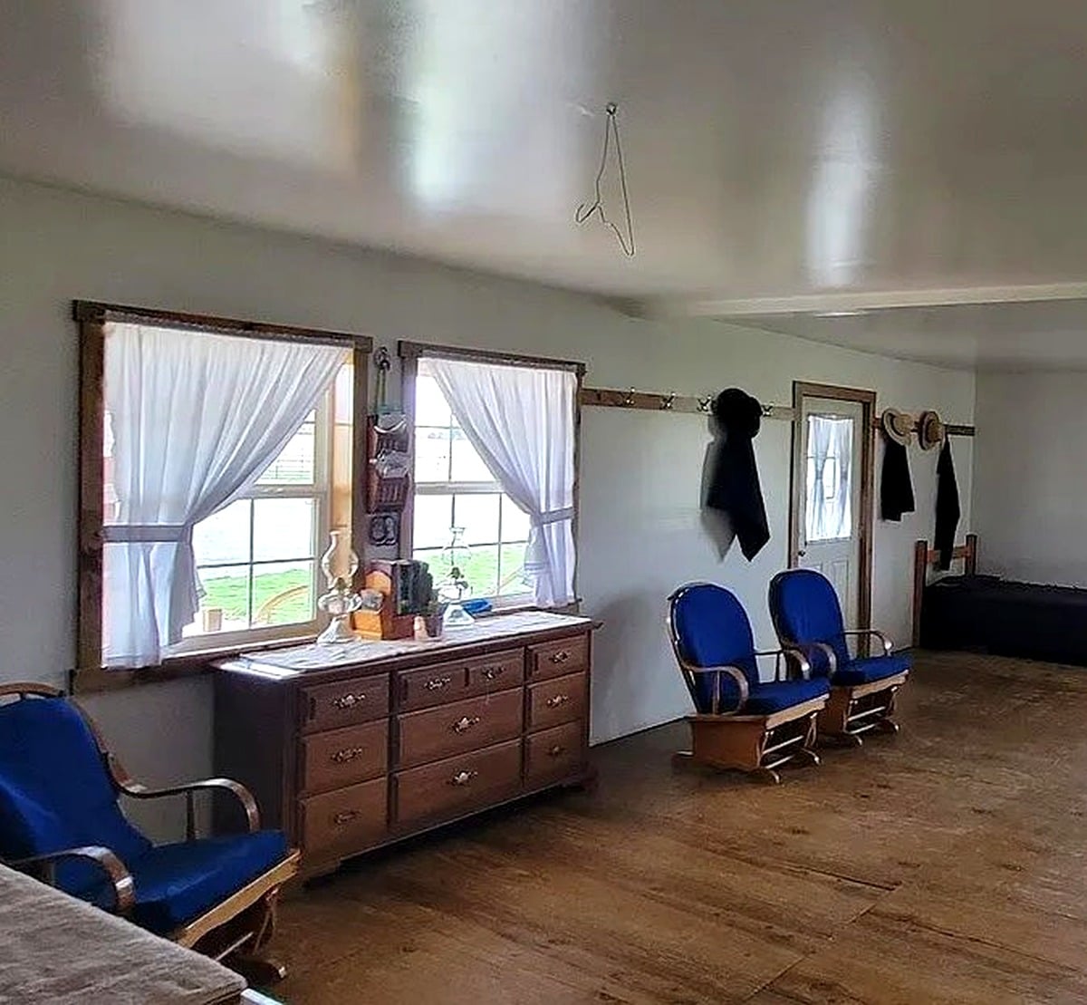 Dresser and coat hooks along wall inside sitting room of Amish home in Vevay, Indiana