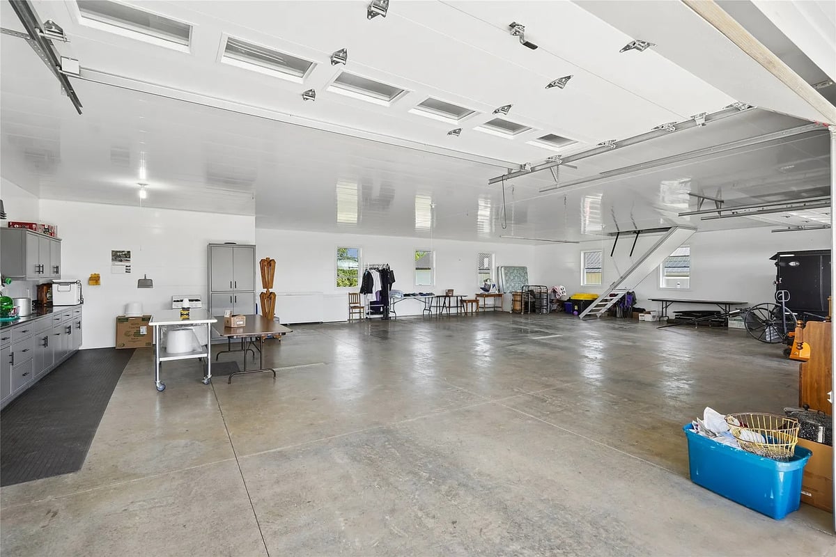 Interior of the heated 3-door garage at the Winterset Amish home Spacious white interior of a 3-door Amish garage with in-floor heat and concrete floor