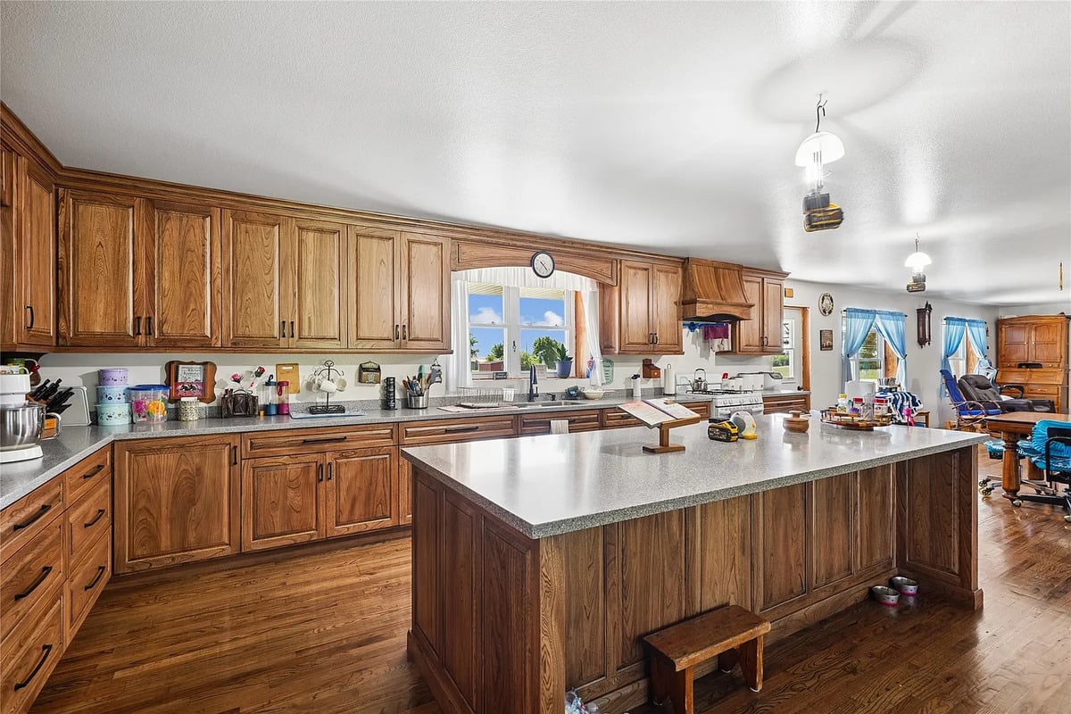 Custom wood island in the Winterset Amish home kitchen Large custom oak kitchen island and matching cabinetry in an Amish home