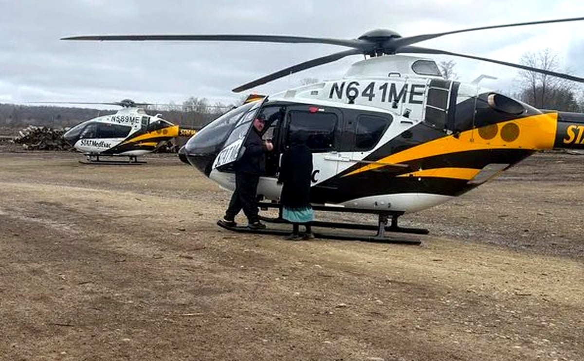 Amish woman next to STAT MedEvac helicopter at scene of Hidden View Amish School fire Crawford County Pennsylvania