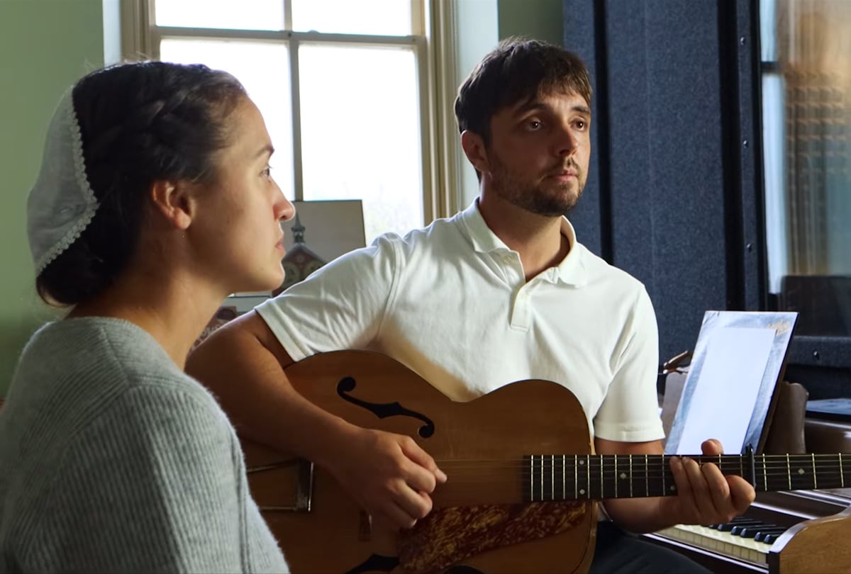 Ben and Rose Performing A Song Ben and Rose performing in a studio with the soft glow of a light