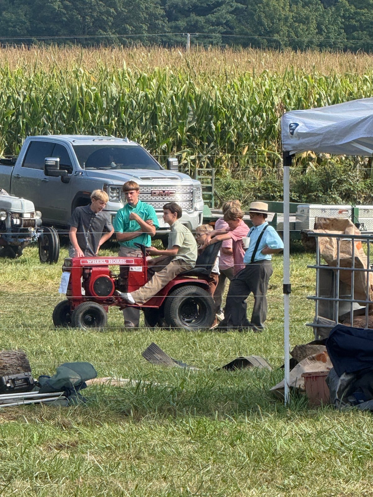 Amish boys gather around a red Wheel Horse garden tractor at Rentown Old Fashion Days