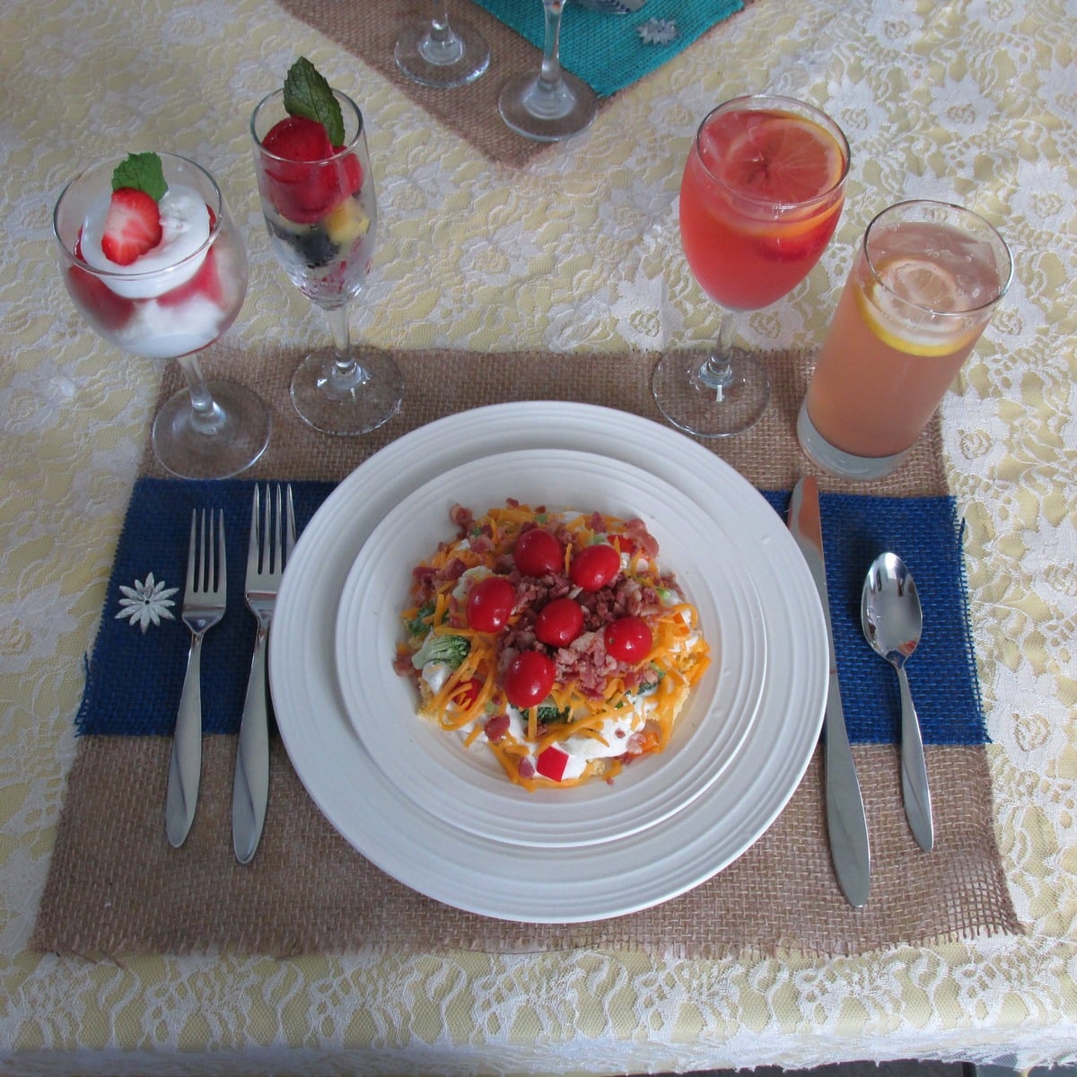 Plated salad at an Amish wedding bridal table with drinks and fruit cups