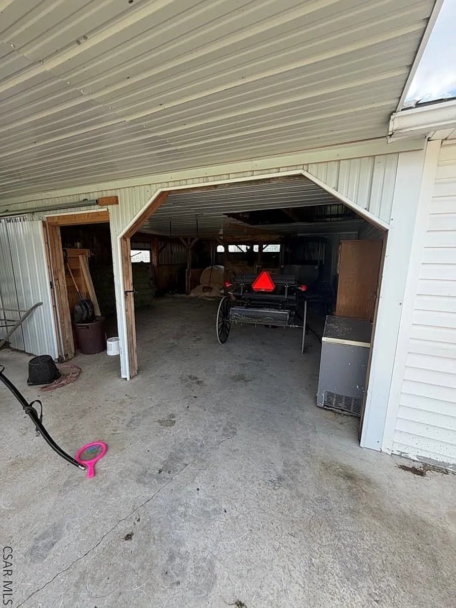 Amish buggy with a slow-moving vehicle triangle parked in a barn in Punxsutawney, Pennsylvania