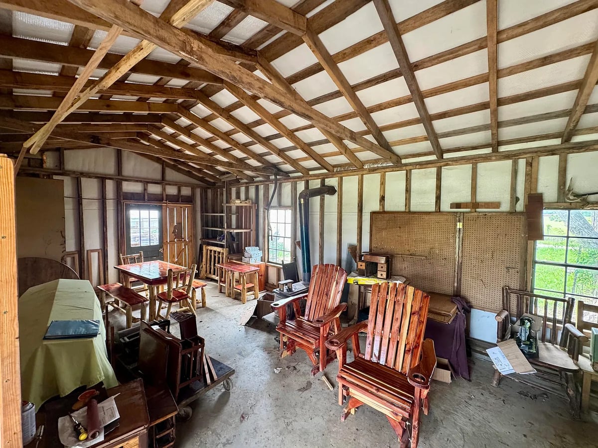 Wooden gliders, table set, and wood stove inside an Amish furniture shop in Mississippi