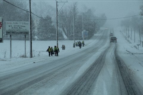 children-walking-roadside-snow