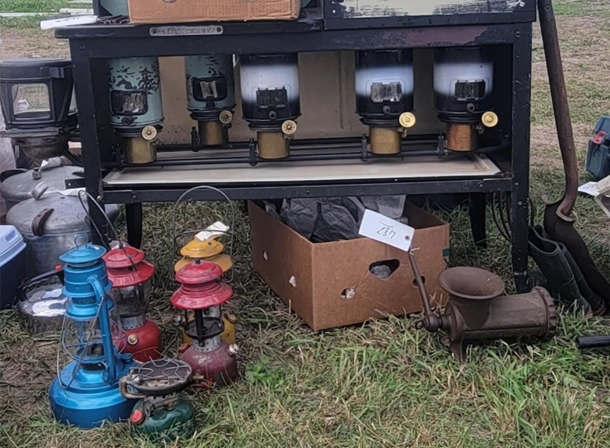 A cookstove with kerosene lanterns and household goods for sale at the Jamesport Amish School Auction