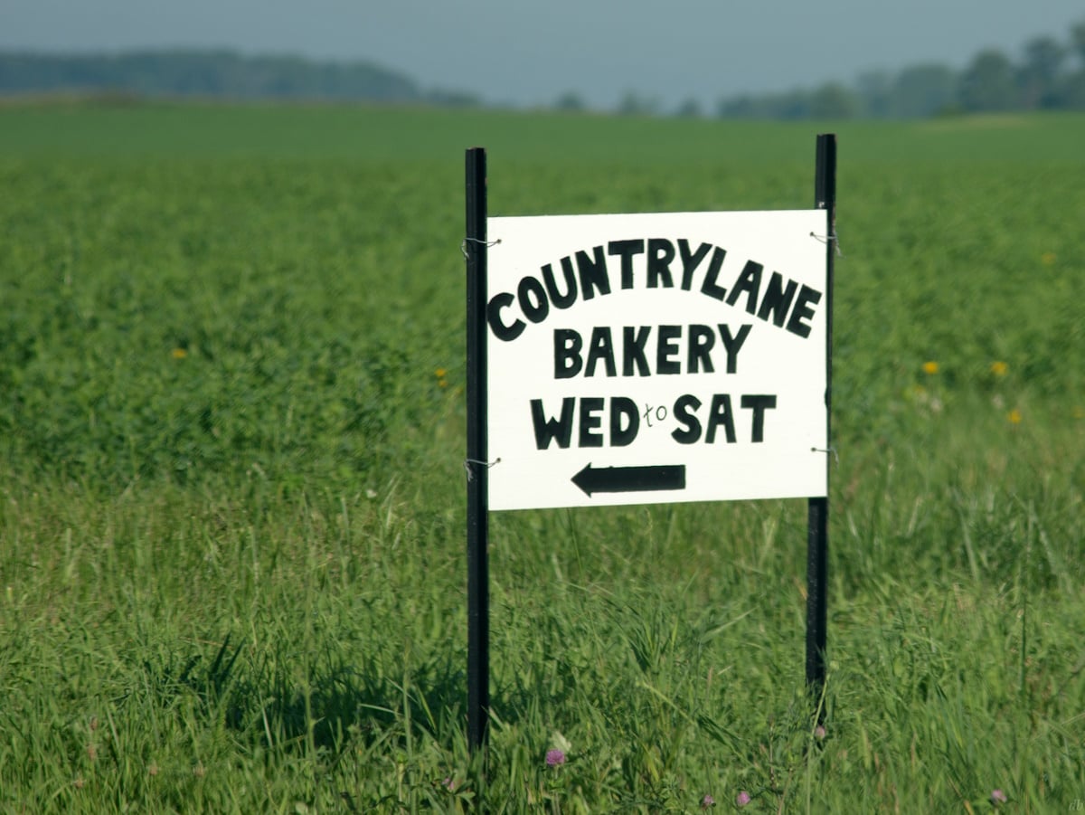 Hand-painted sign outside an Amish bakery in Indiana showing baked goods offerings