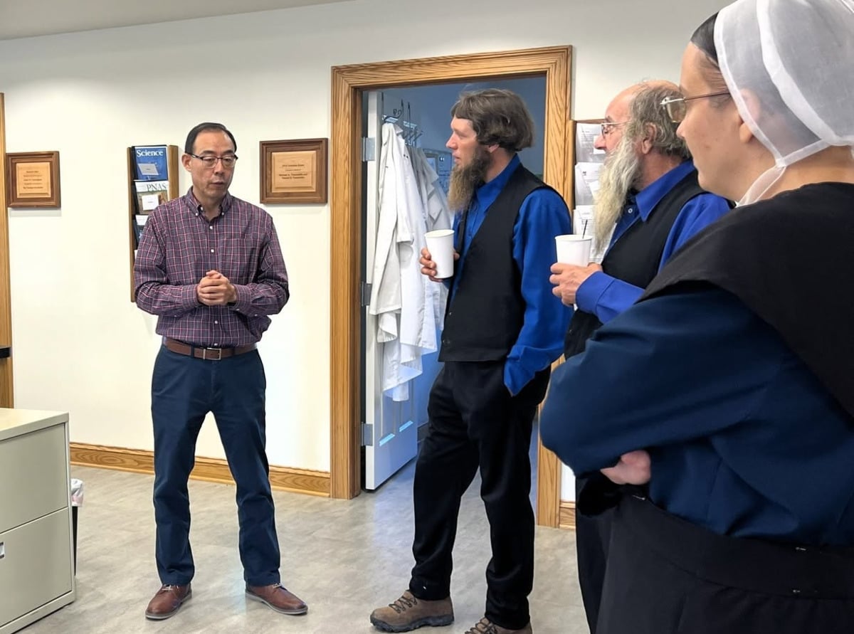 Dr. Baozhong Xin speaks with Amish community members at the DDC Clinic in Middlefield, Ohio