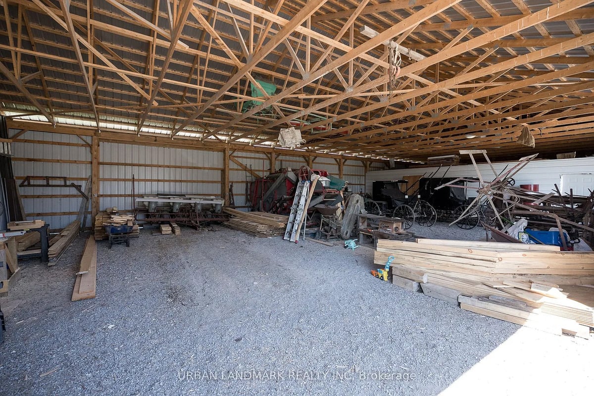 Buggies in an Amish drive shed near Stirling, Ontario Inside an Amish drive shed with buggies, farm equipment and lumber in Ontario