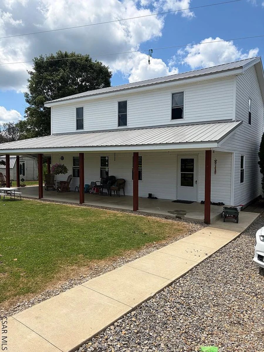 Two-story Amish home with a long covered front porch in Punxsutawney, Pennsylvania