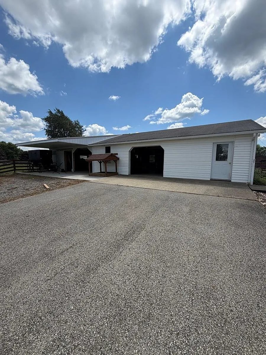 Garage and barn building with an Amish buggy parked under a covered area