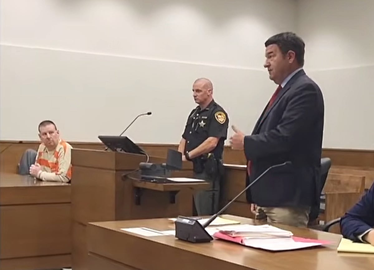 Geauga County courtroom hearing in Amish home invasion case Defendant in jail clothing seated in a Geauga County, Ohio courtroom as an attorney addresses the judge, with a sheriff's deputy standing behind