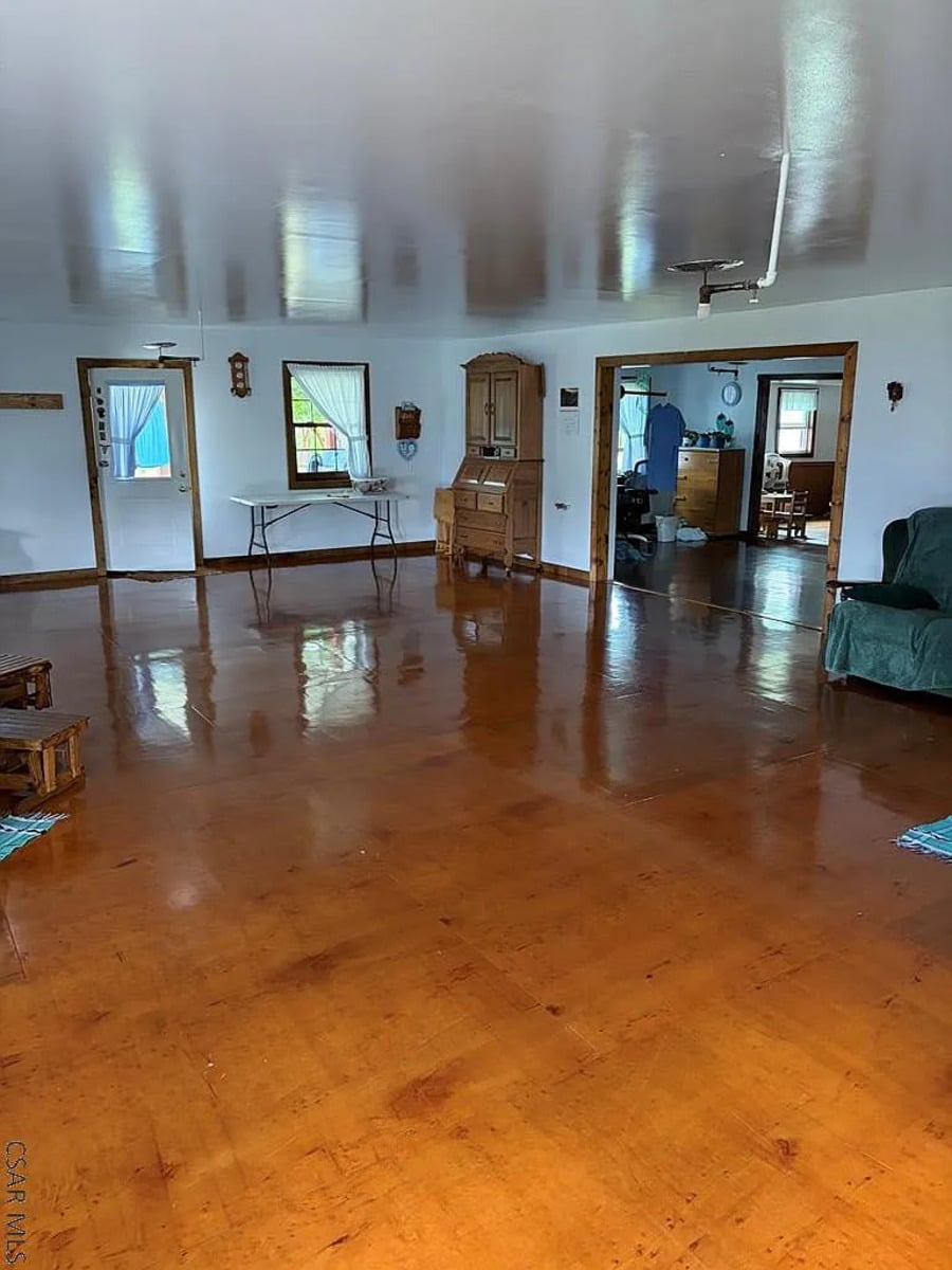 Great room with a glossy wood floor and a secretary desk in a Punxsutawney, PA Amish home