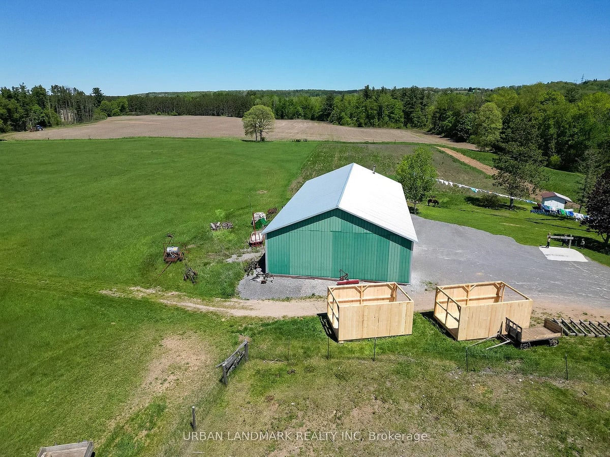 Drive shed on an Amish farm in Ontario Green metal drive shed with two new wooden sheds on an Amish farm near Stirling, Ontario