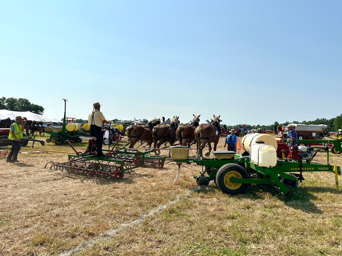 Equipment demo prep – Horse Progress Days 2026 Amish men prepping horse-drawn equipment for demo at Horse Progress Days 2026