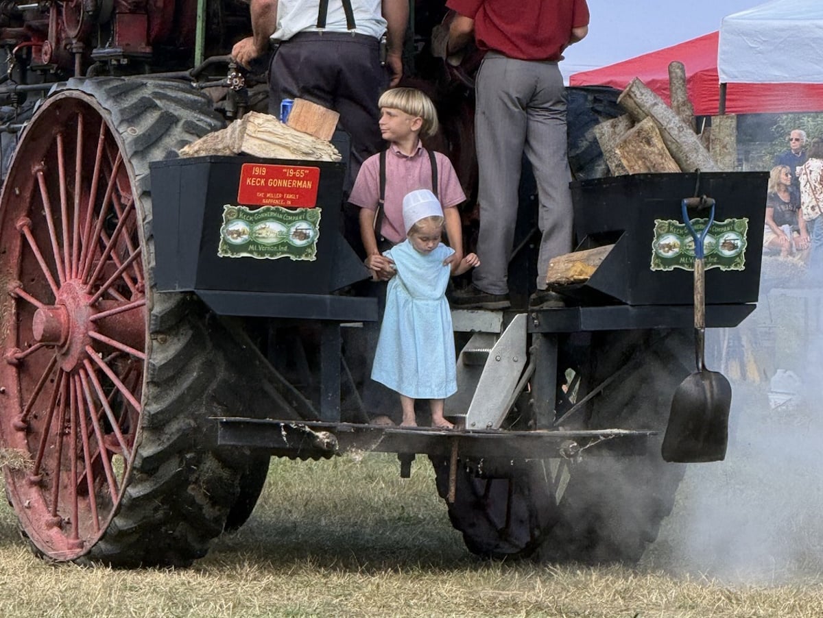 Amish children on a 1919 Keck Gonnerman steam engine at Old Fashion Days in northern Indiana
