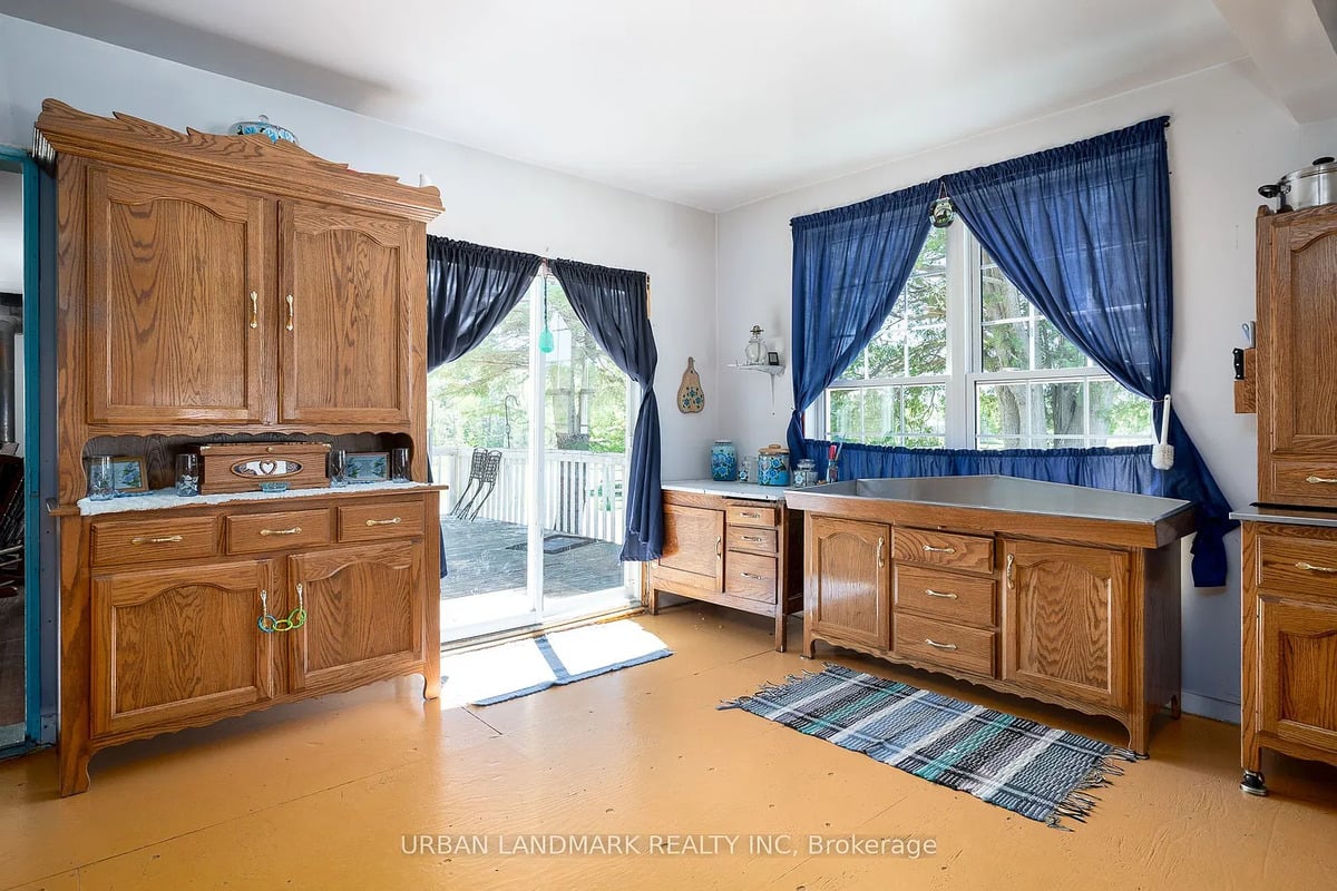 Oak cabinets in an Ontario Amish kitchen Oak kitchen cabinets, blue curtains and patio doors in an Amish home near Stirling, Ontario