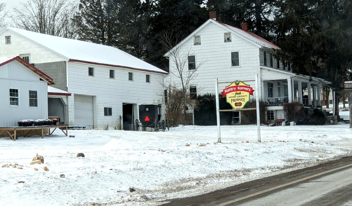 Kuntry Korners Amish produce stand in Grantsville Maryland in winter with buggy parked outside and home-grown produce sign