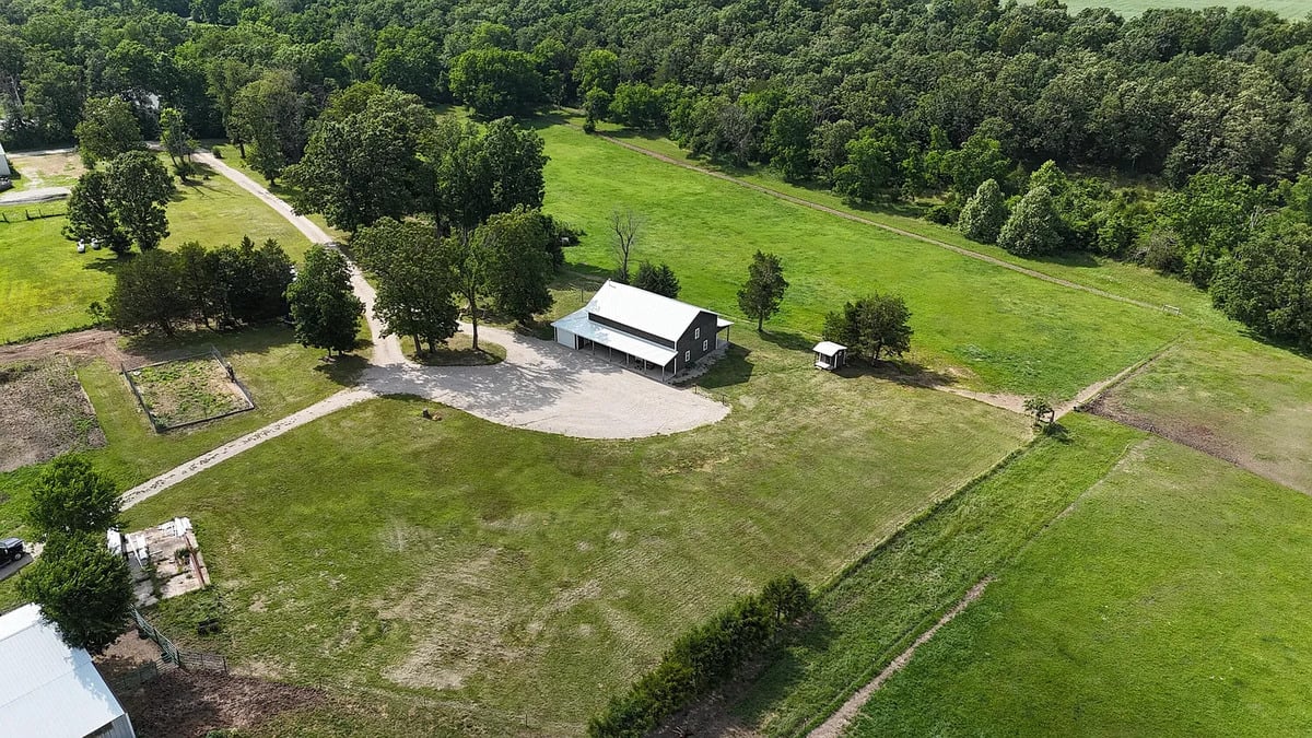 Aerial view of an Amish homestead surrounded by pasture and timber in Webster County, Missouri