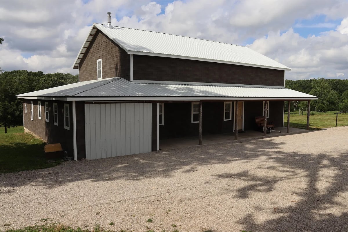 Closer view of the Amish home's covered porch and an enclosed bay at one end