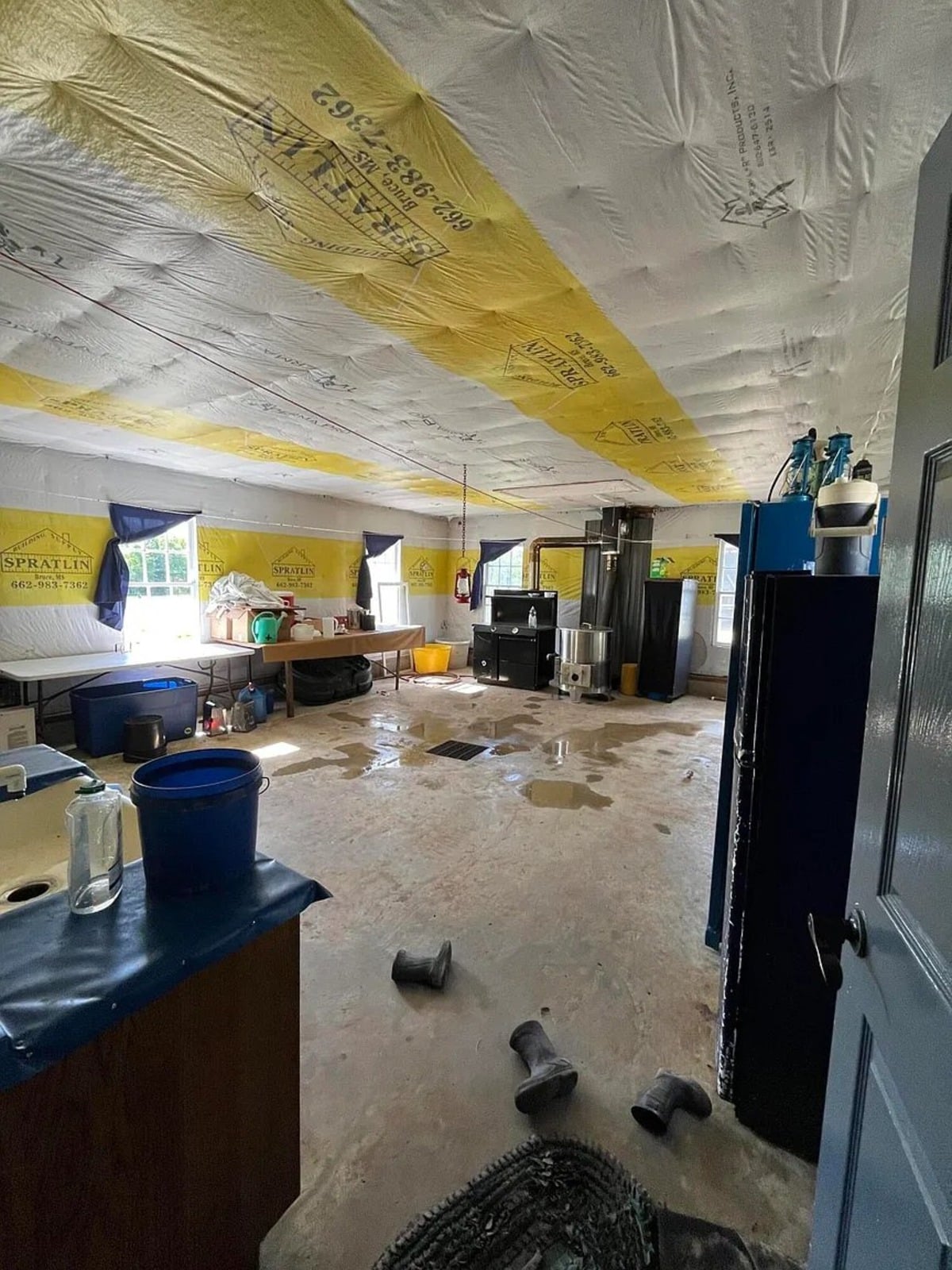 Unfinished basement room with foil insulation on ceiling and bare concrete floor, Amish home in Randolph Mississippi