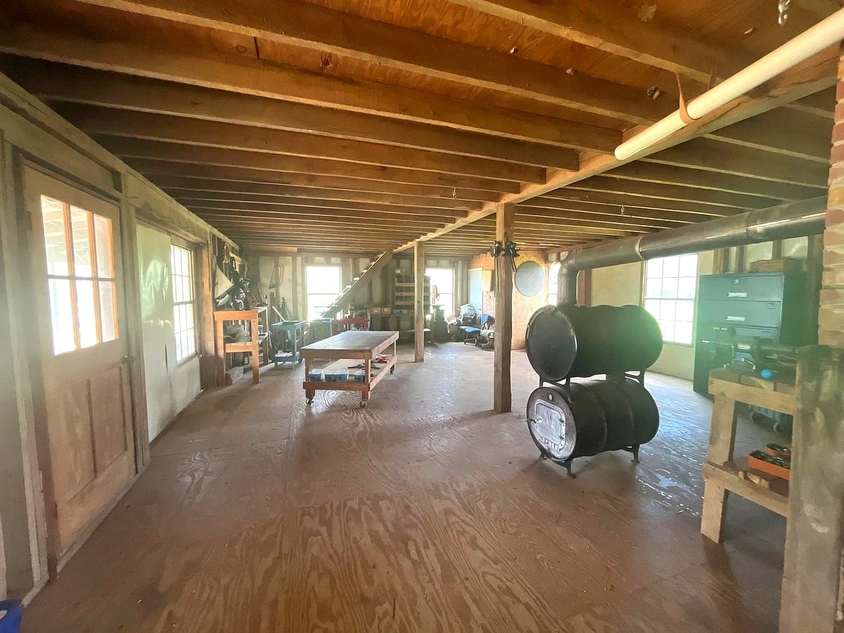 Interior of Amish furniture workshop in Mississippi with workbenches and barrel wood stove
