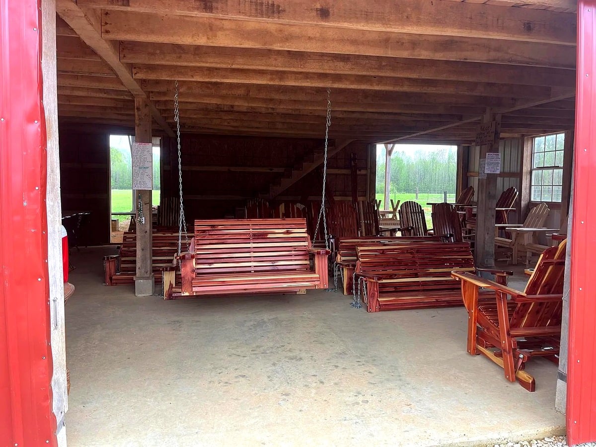 Amish-made porch swings, Adirondack chairs and rockers inside a furniture showroom in Mississippi