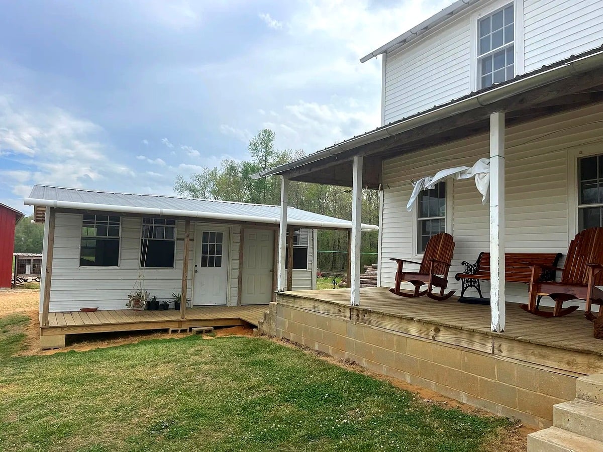 Covered front porch with wooden rockers on a Swartzentruber Amish home in Mississippi