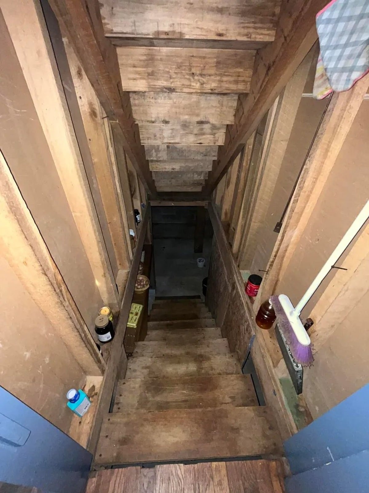 Steep narrow wooden staircase leading to basement in Swartzentruber Amish home, Randolph Mississippi