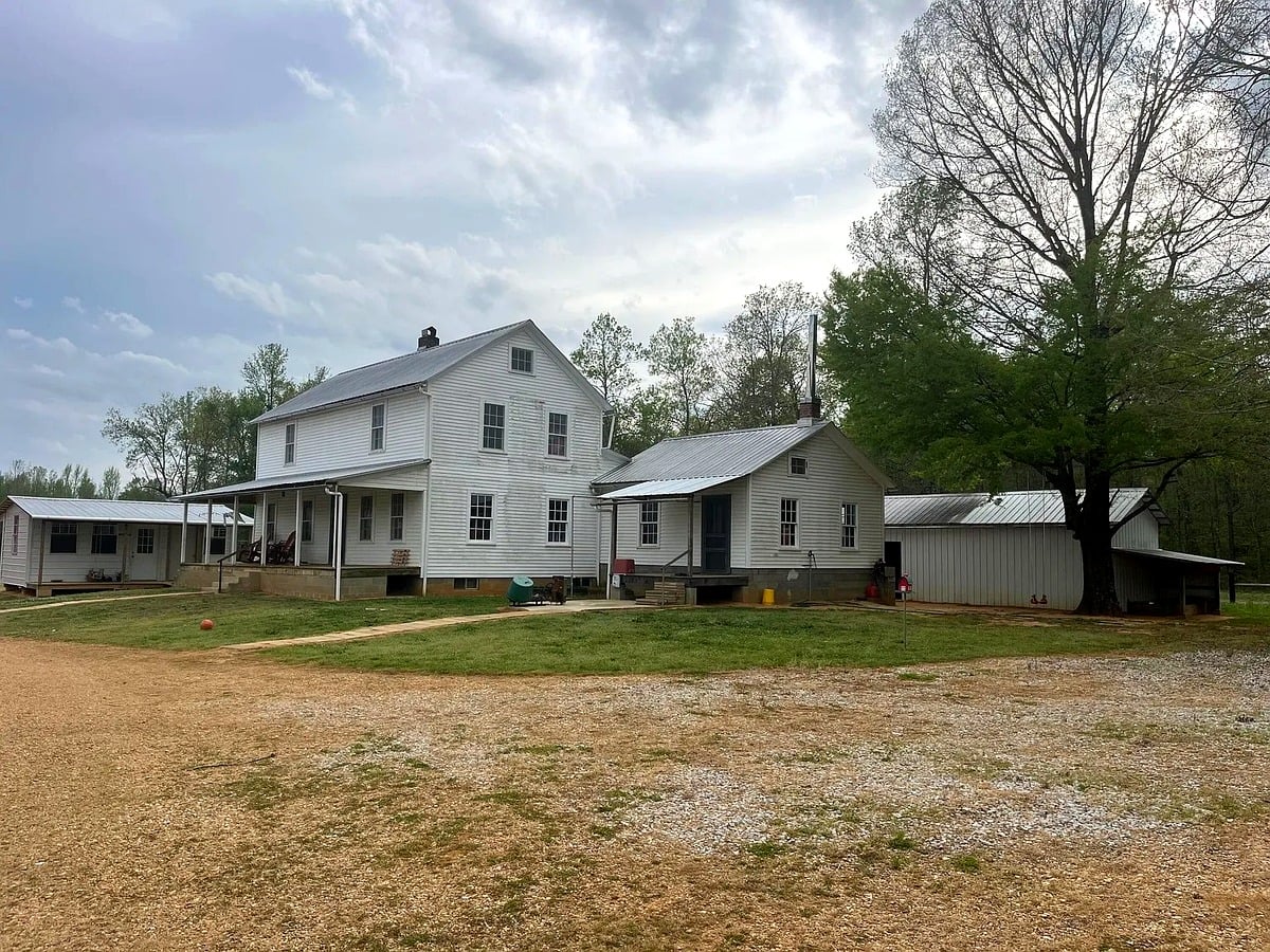 Wide view of Amish homestead in Pontotoc County, Mississippi showing main house and outbuildings